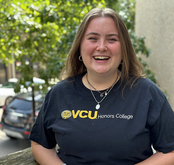 Laina Atkins wearing a black and gold Honors College shirt