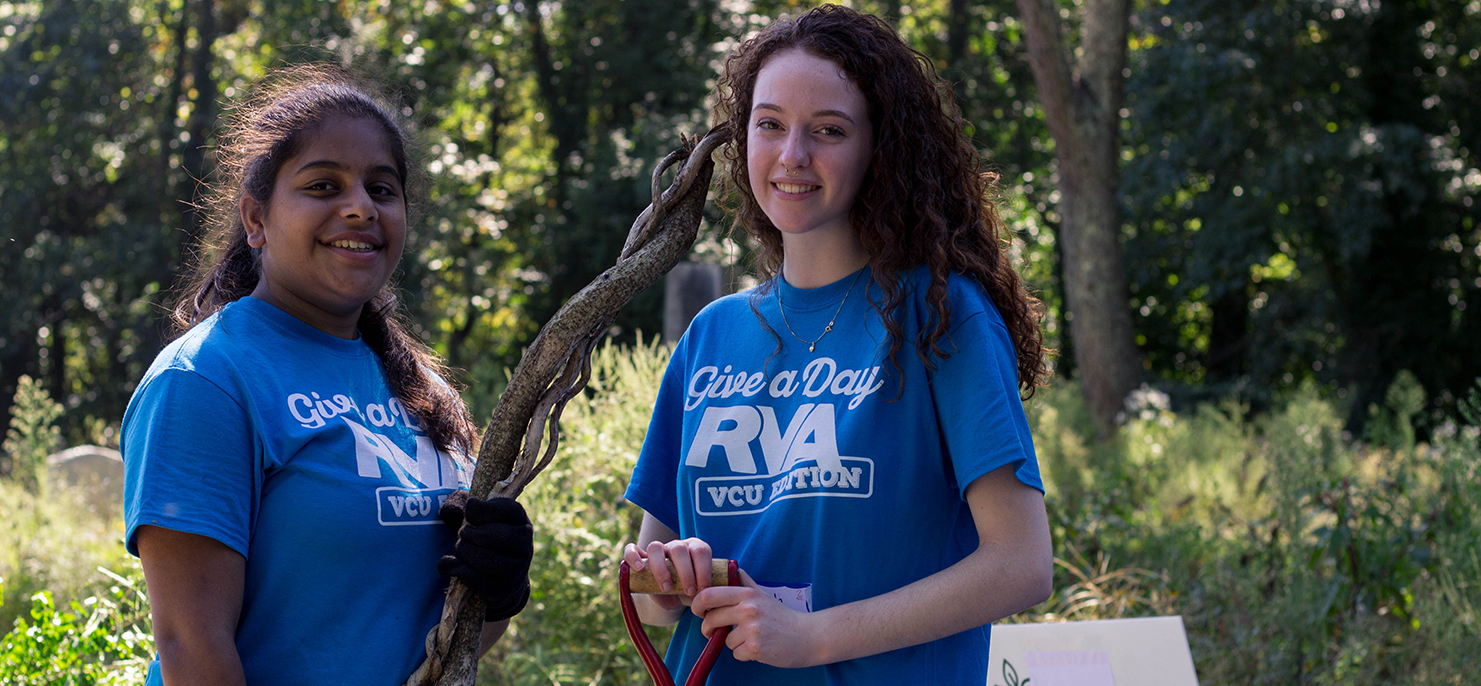 Two Honors students pause for a photo during a community cleanup event